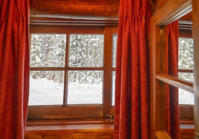 Cabin interior with chess by fireplace