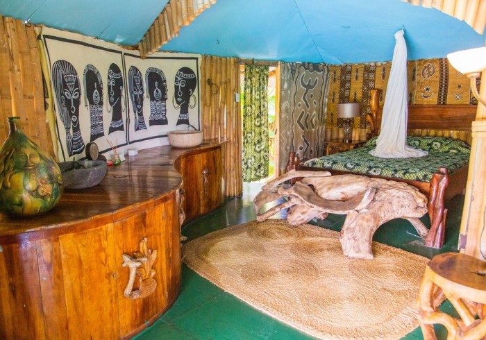 Spacious hut suite at Great Huts eco resort in Portland Jamaica with sitting area and art pieces