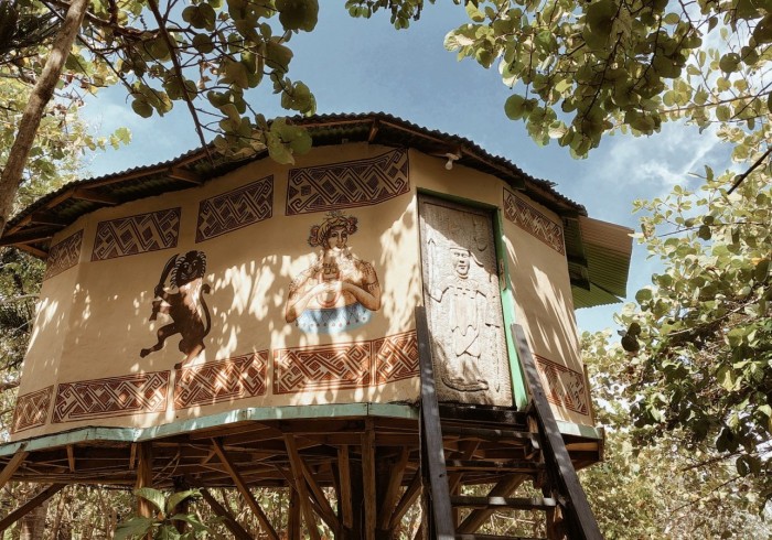 Spacious hut suite at Great Huts eco resort in Portland Jamaica with sitting area and art pieces