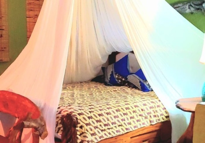 Spacious hut suite at Great Huts eco resort in Portland Jamaica with sitting area and art pieces