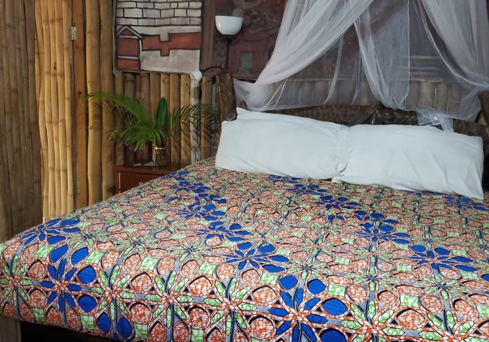 Spacious hut suite at Great Huts eco resort in Portland Jamaica with sitting area and art pieces