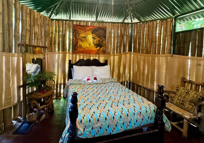 Spacious hut suite at Great Huts eco resort in Portland Jamaica with sitting area and art pieces