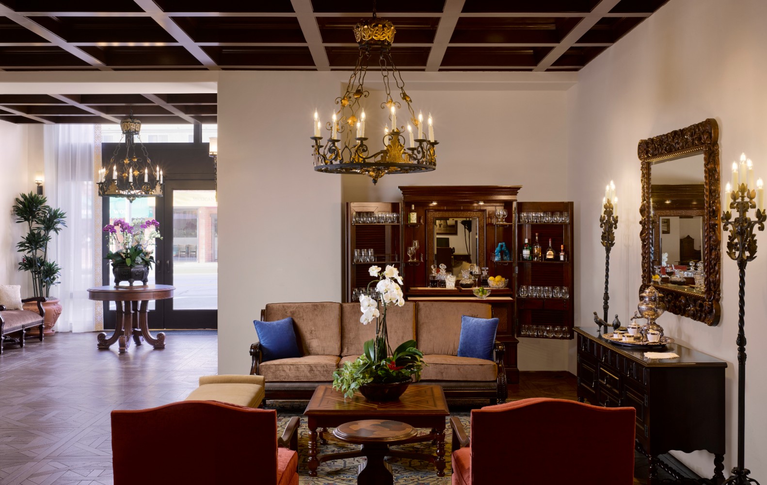 A luxurious lobby with a bar, seating area, and elegant decor